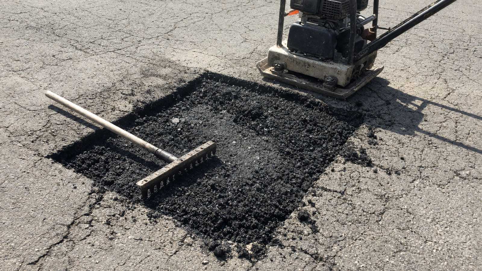 Saw-cut full-depth asphalt patch being filled with hot-mix — asphalt paving in Riverside, CA
